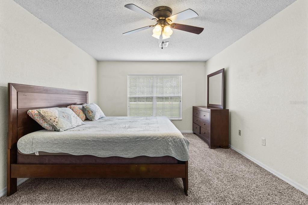 16038 Malden Road Weeki Wachee, FL 34614 - Photo 20 of 40 a bedroom with a bed and a chandelier