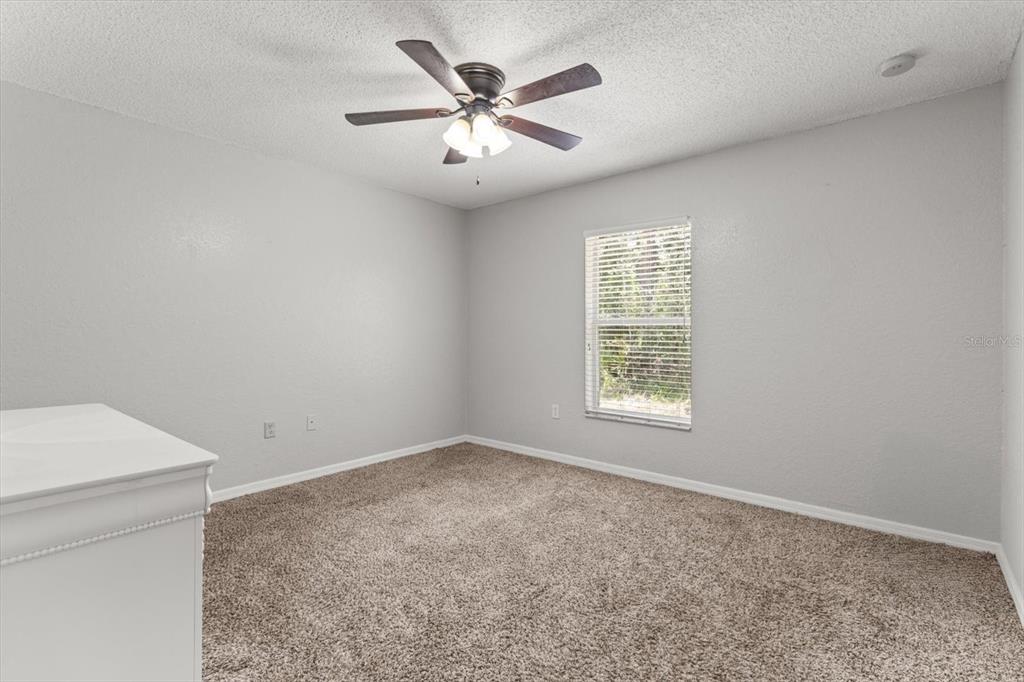 16038 Malden Road Weeki Wachee, FL 34614 - Photo 23 of 40 an empty room with a window and a ceiling fan