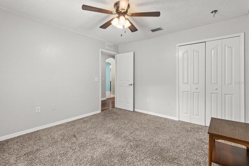 16038 Malden Road Weeki Wachee, FL 34614 - Photo 25 of 40 a view of an empty room and chandelier fan