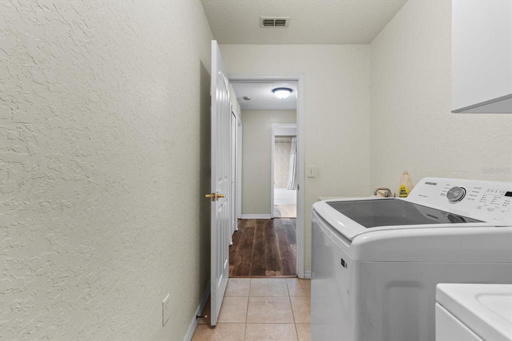 16038 Malden Road Weeki Wachee, FL 34614 - Photo 28 of 40 a utility room with a sink dryer and washer