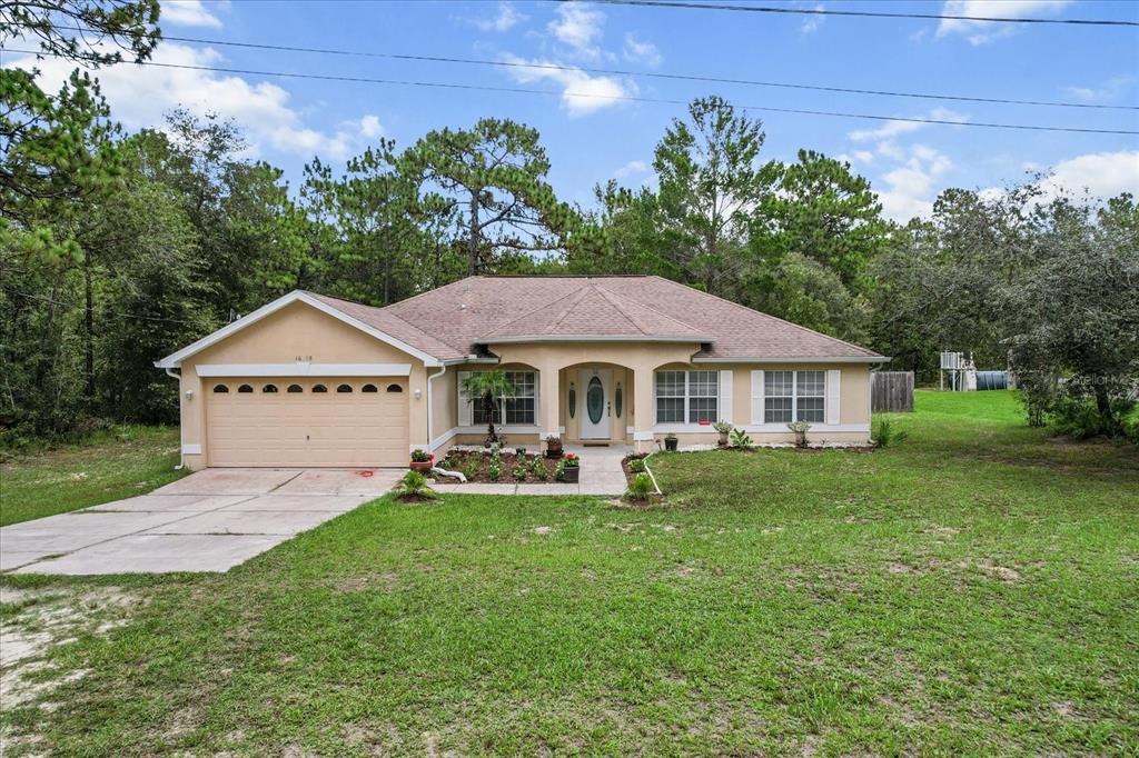 16038 Malden Road Weeki Wachee, FL 34614 - Photo 31 of 40 a front view of a house with garden