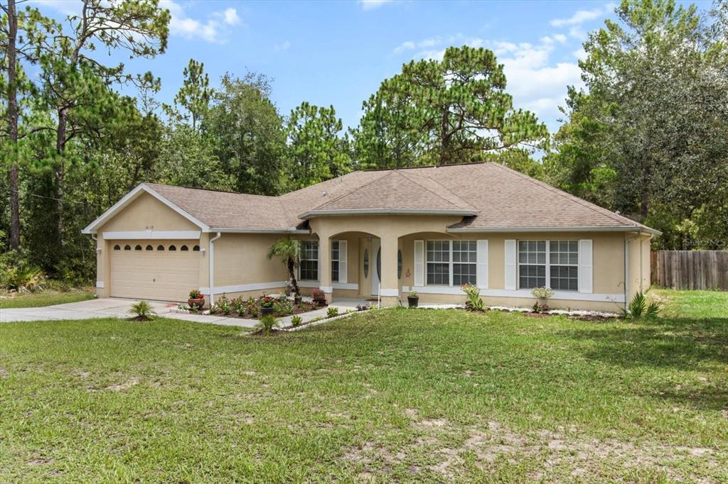 16038 Malden Road Weeki Wachee, FL 34614 - Photo 33 of 40 a front view of a house with garden
