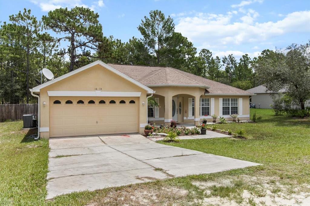 16038 Malden Road Weeki Wachee, FL 34614 - Photo 34 of 40 a front view of a house with garden