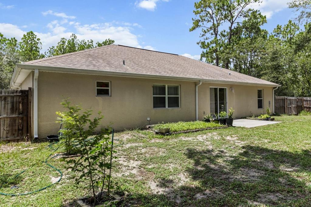 16038 Malden Road Weeki Wachee, FL 34614 - Photo 36 of 40 a backyard of a house with table and chairs