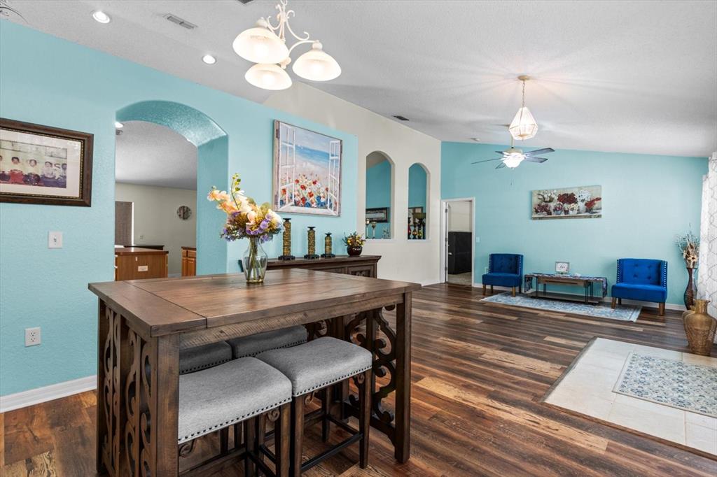 16038 Malden Road Weeki Wachee, FL 34614 - Photo 10 of 40 a view of a dining room with furniture and wooden floor