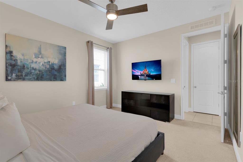 7403 Marker Avenue Kissimmee, FL 34747 - Photo 14 of 49 a bedroom with a bed and a fireplace