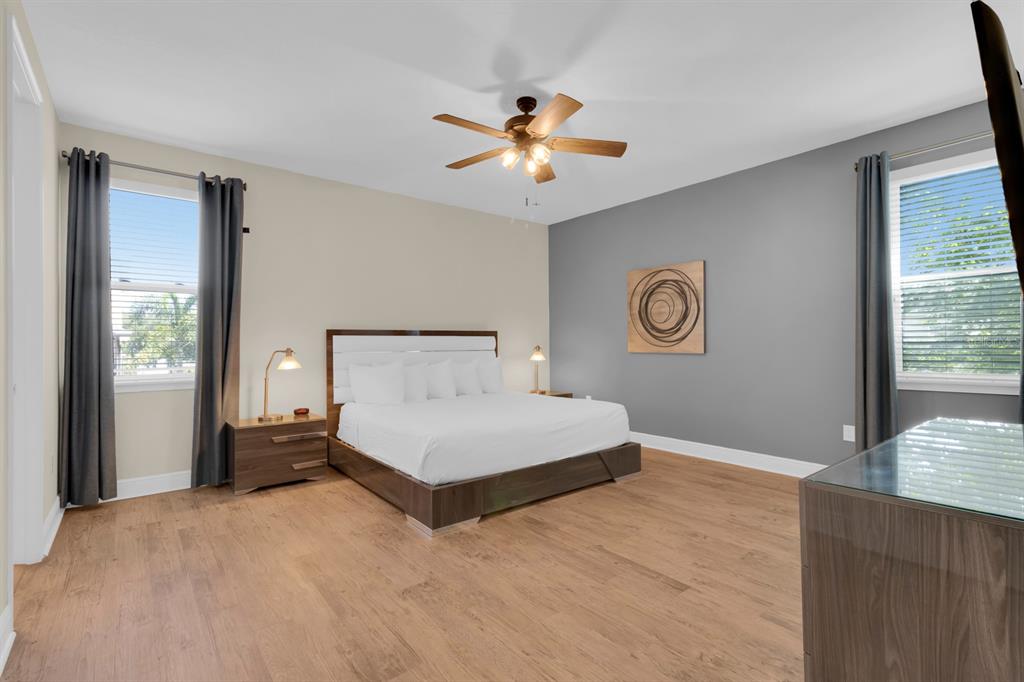 7403 Marker Avenue Kissimmee, FL 34747 - Photo 21 of 49 a bedroom with a bed and a chandelier