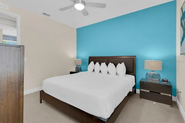 a bedroom with a bed and a chandelier