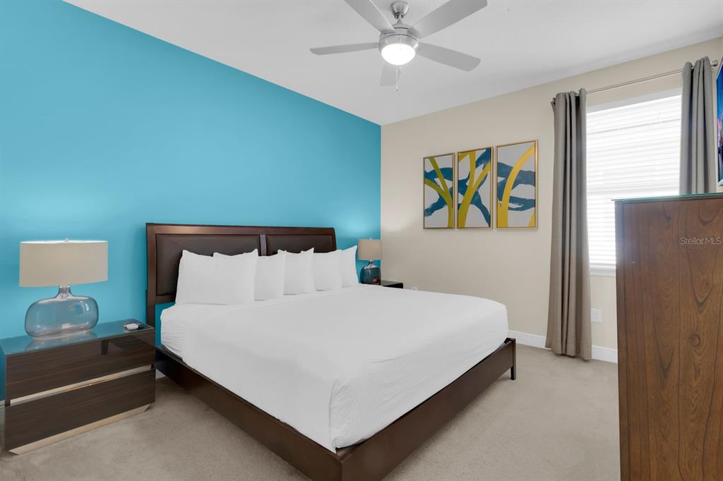 7403 Marker Avenue Kissimmee, FL 34747 - Photo 29 of 49 a bedroom with a bed and a chandelier