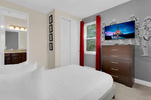 a bedroom with a bed and a lamp