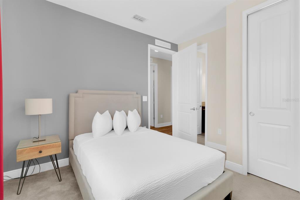 7403 Marker Avenue Kissimmee, FL 34747 - Photo 32 of 49 a bedroom with a bed and a lamp