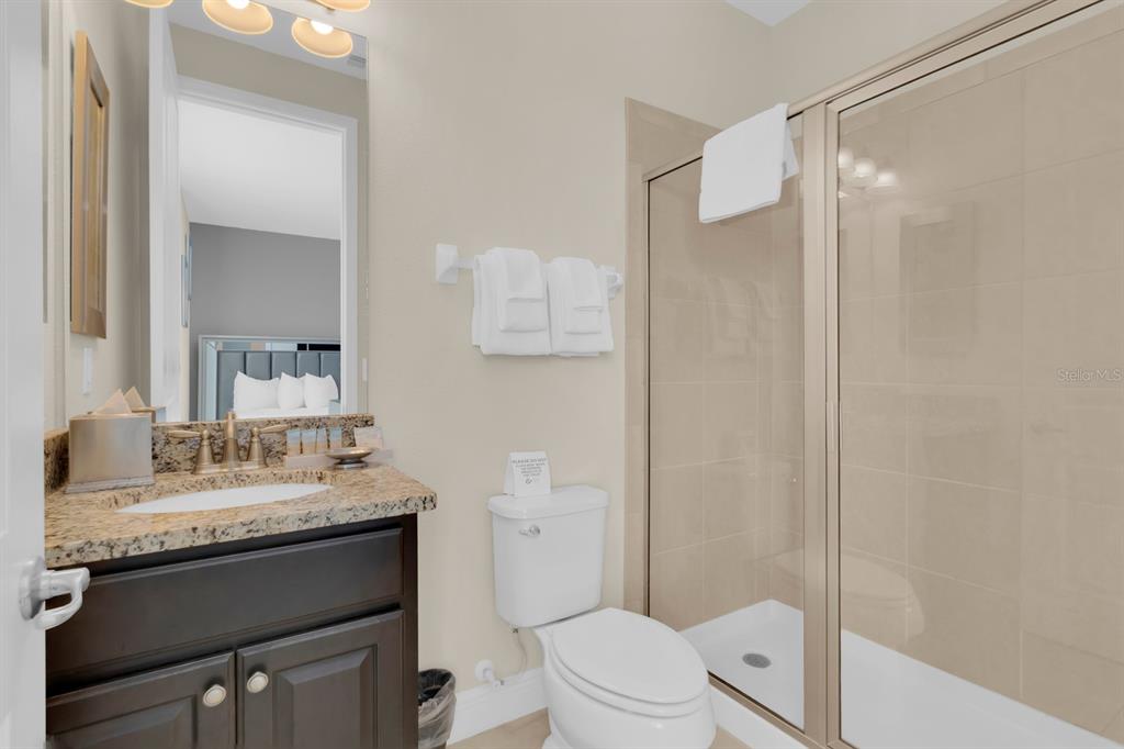 7403 Marker Avenue Kissimmee, FL 34747 - Photo 34 of 49 a bathroom with a sink vanity mirror and toilet