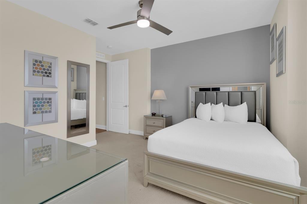 7403 Marker Avenue Kissimmee, FL 34747 - Photo 35 of 49 a bedroom with a large bed and a chandelier