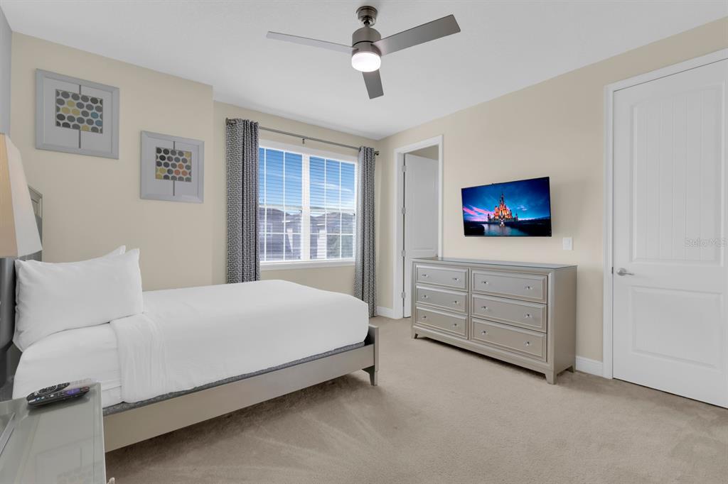 7403 Marker Avenue Kissimmee, FL 34747 - Photo 36 of 49 a bedroom with a bed and a flat screen tv