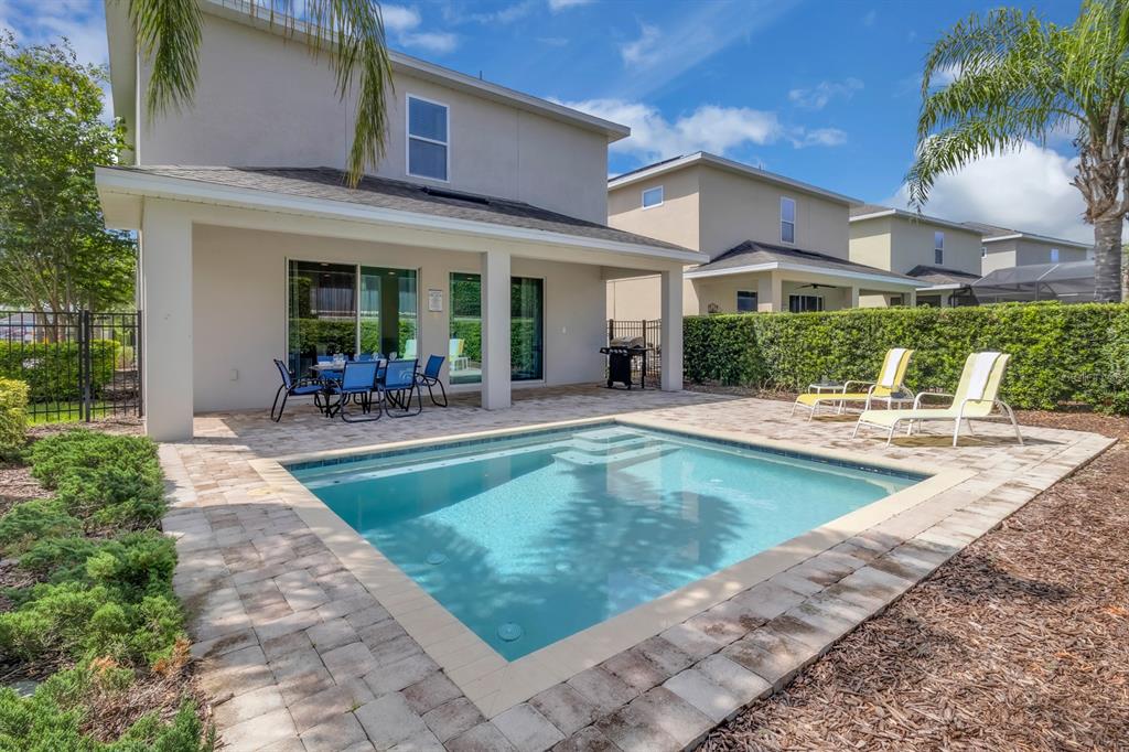 7403 Marker Avenue Kissimmee, FL 34747 - Photo 38 of 49 a view of a house with swimming pool patio and a porch
