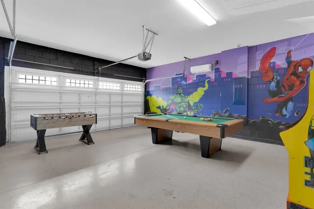 a living room with furniture and a wall painting