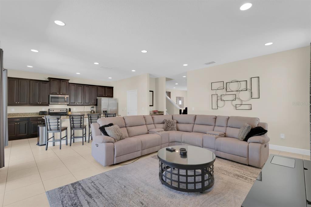 7403 Marker Avenue Kissimmee, FL 34747 - Photo 9 of 49 a living room with lots of furniture and kitchen view