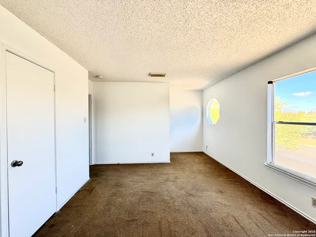 a view of a roof deck with wooden fence and a bench