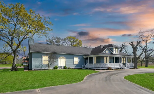 a front view of house with yard and green space
