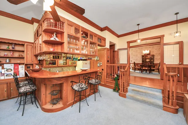 a dining room with furniture and a floor to ceiling window