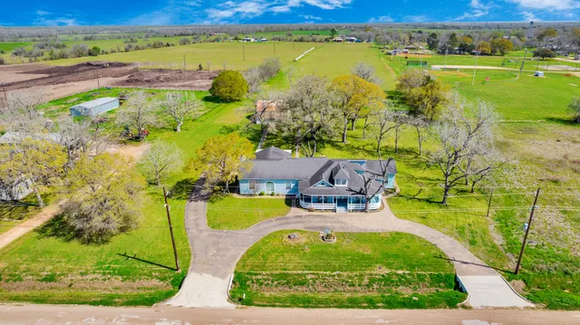 an aerial view of a swimming pool with a yard
