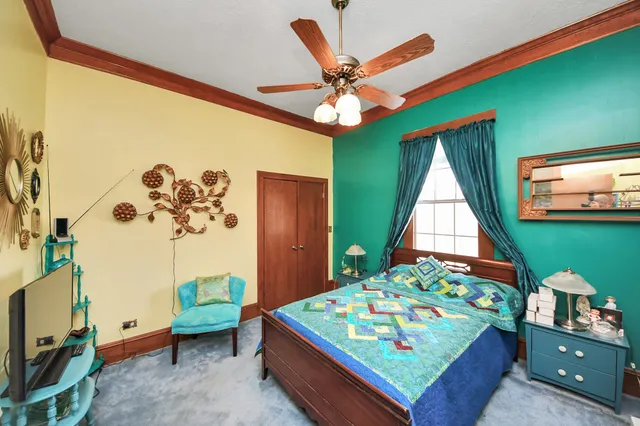 a living room with furniture gym equipment and a chandelier