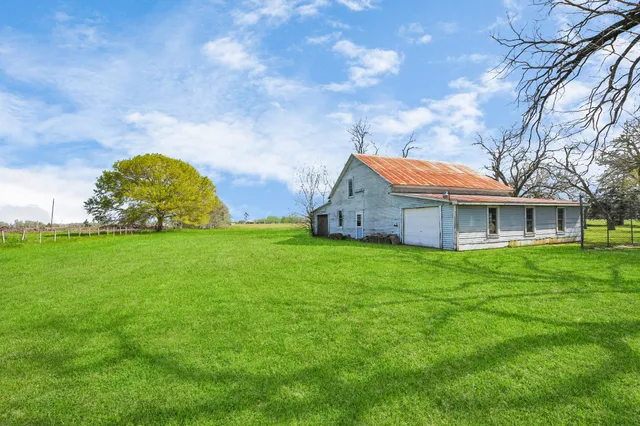 a view of a patio with table and chairs