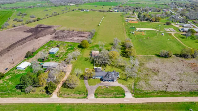 an aerial view of a houses with a yard
