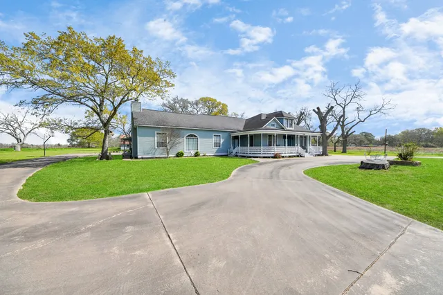 a front view of a house with yard and porch