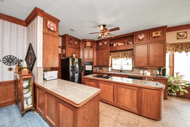 a kitchen with stainless steel appliances granite countertop a sink and cabinets