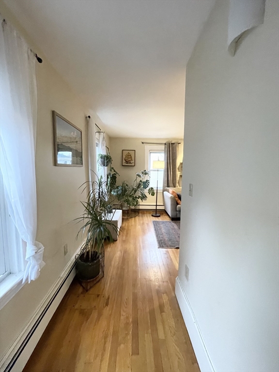 2 Hagar Street, Unit 2 Boston, MA 02130 - Photo 14 of 19 a view of a living room and a livingroom with wooden floor
