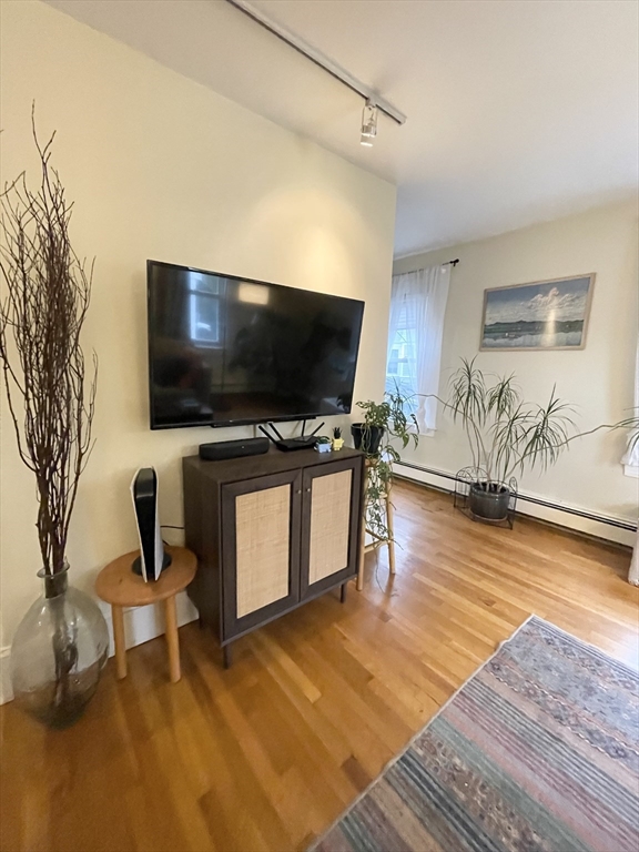 2 Hagar Street, Unit 2 Boston, MA 02130 - Photo 3 of 19 a living room with furniture and a flat screen tv