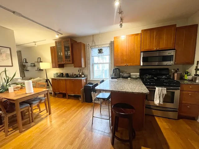 a kitchen with a sink appliances and cabinets