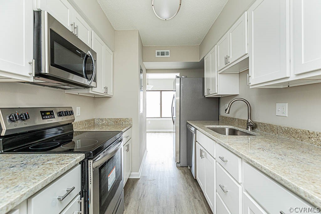 1511 Regency Woods Road, Unit 302 Henrico, VA 23238 - Photo 1 of 23 a kitchen with stainless steel appliances granite countertop a sink stove and microwave