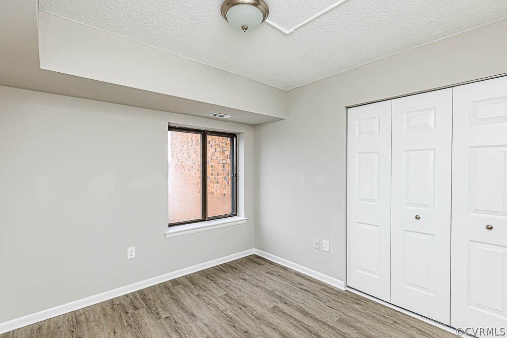 1511 Regency Woods Road, Unit 302 Henrico, VA 23238 - Photo 16 of 23 wooden floor in an empty room with a window