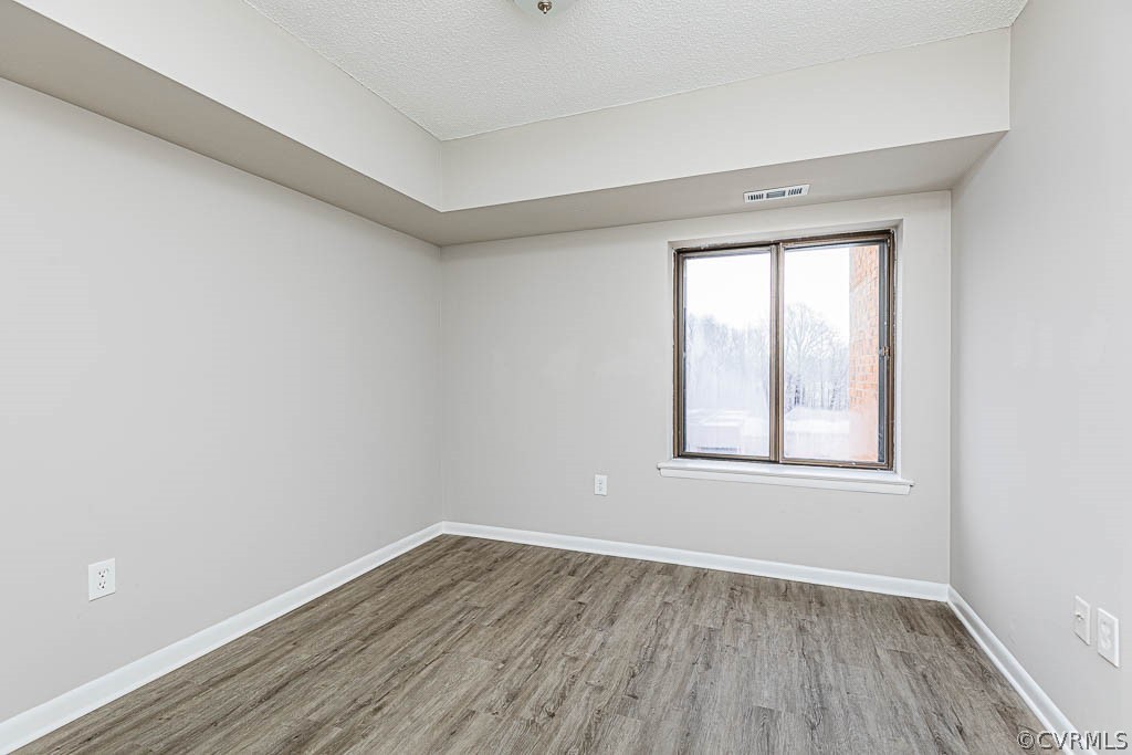 1511 Regency Woods Road, Unit 302 Henrico, VA 23238 - Photo 17 of 23 an empty room with wooden floor and windows