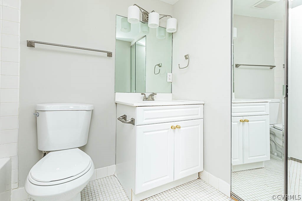 1511 Regency Woods Road, Unit 302 Henrico, VA 23238 - Photo 19 of 23 a bathroom with a toilet a sink and a mirror