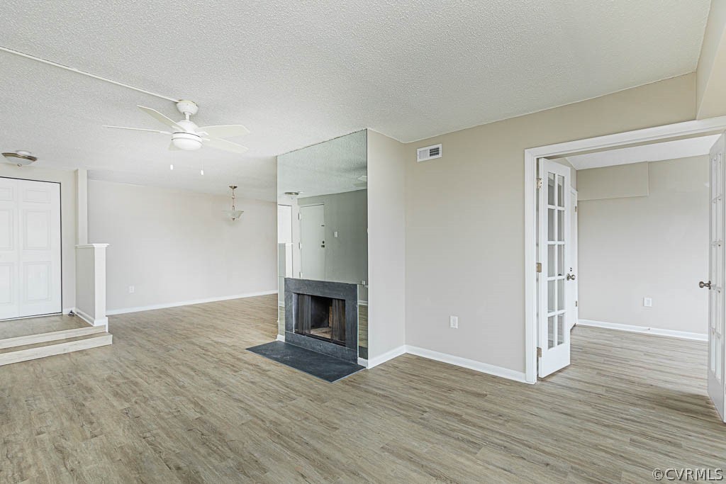 1511 Regency Woods Road, Unit 302 Henrico, VA 23238 - Photo 4 of 23 an empty room with wooden floor fireplace and windows