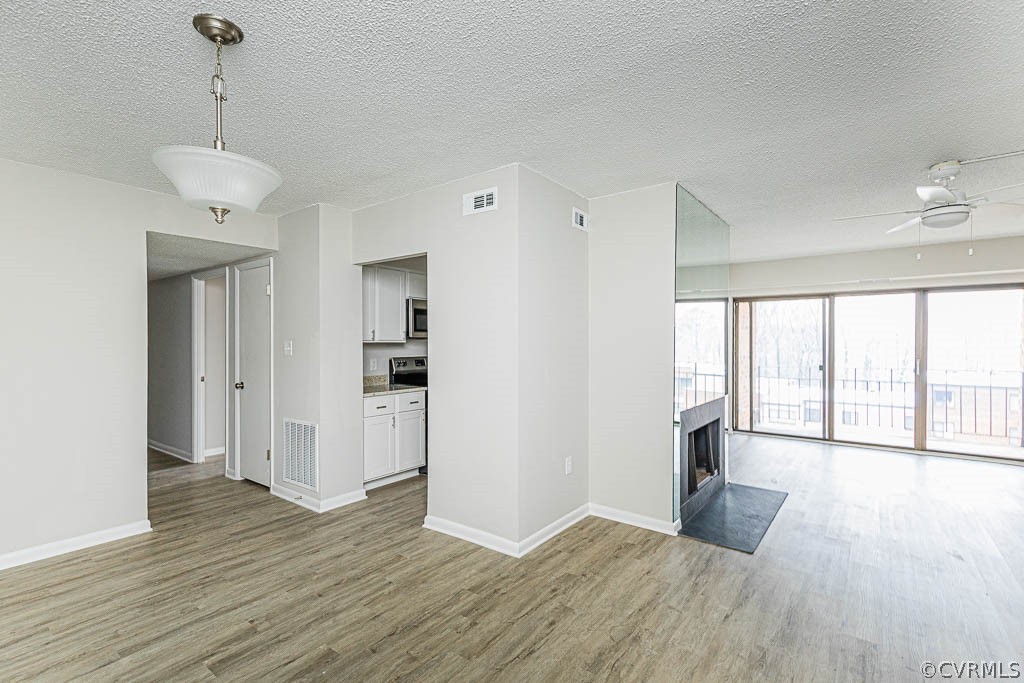 1511 Regency Woods Road, Unit 302 Henrico, VA 23238 - Photo 6 of 23 a view of an empty room with wooden floor and a window
