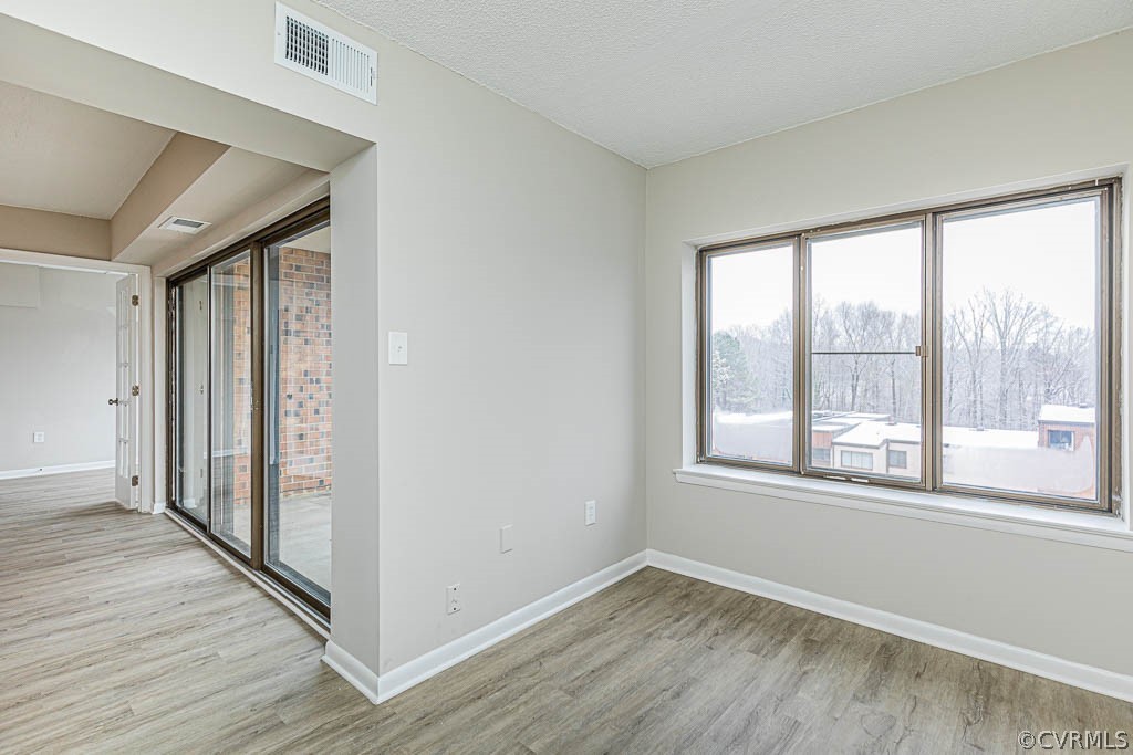 1511 Regency Woods Road, Unit 302 Henrico, VA 23238 - Photo 8 of 23 a view of an empty room with wooden floor and a window