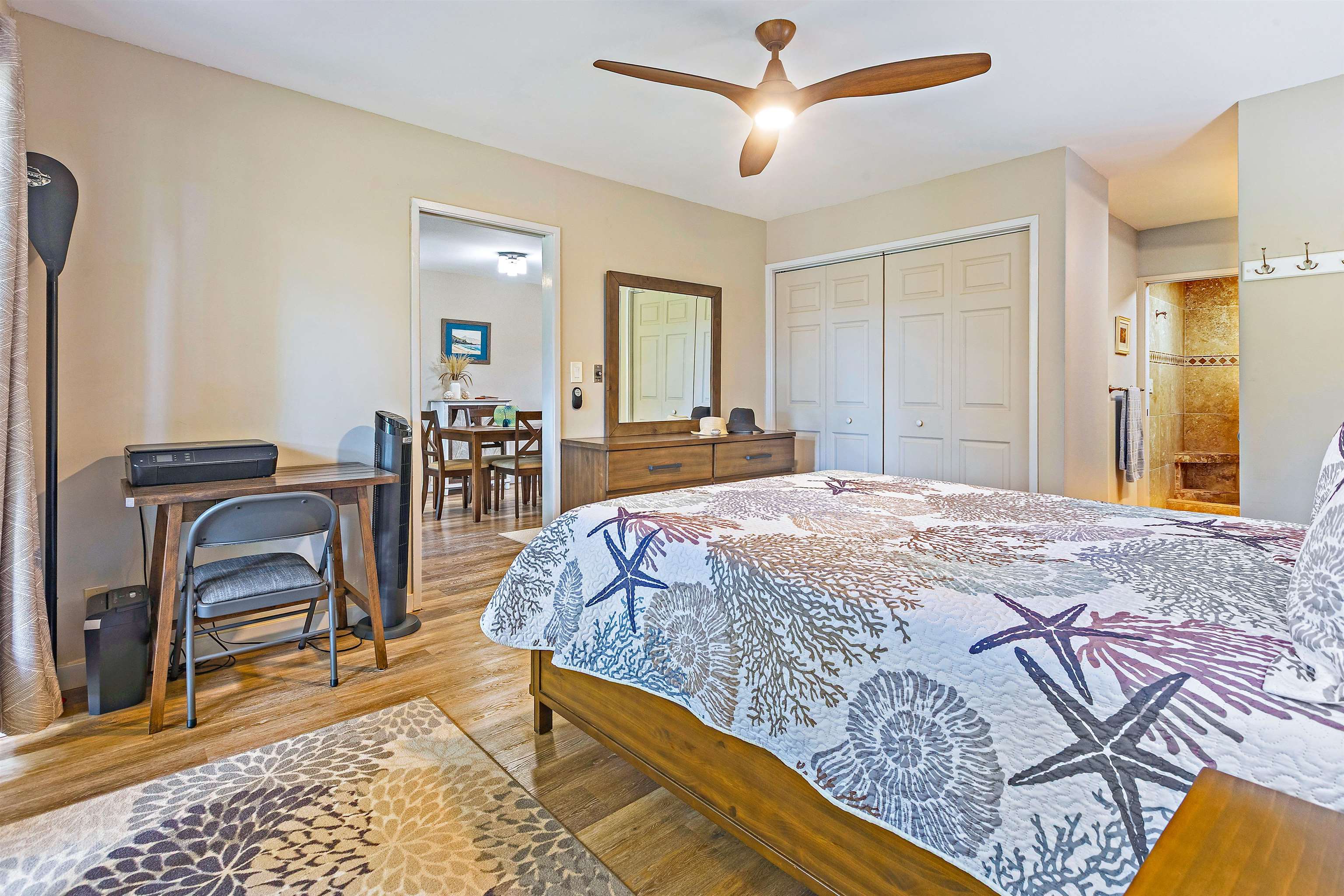 3788 Lower Honoapiilani Road, Unit A110 Lahaina, HI 96761 - Photo 15 of 35 a bedroom with a bed a dresser and chair