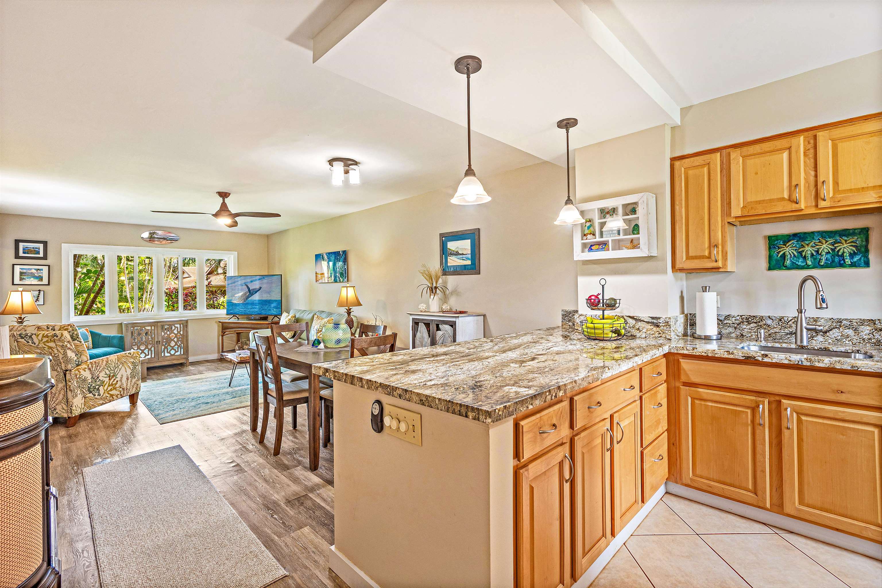 3788 Lower Honoapiilani Road, Unit A110 Lahaina, HI 96761 - Photo 10 of 35 a open kitchen with stainless steel appliances granite countertop a stove top oven a sink dishwasher and white cabinets with wooden floor