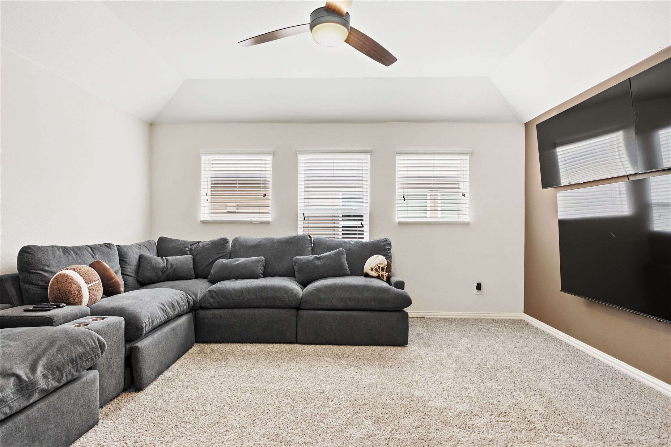 486 Pond View Pass Buda, TX 78610 - Photo 20 of 39 Carpeted bonus room with a vaulted ceiling and three windows featuring blinds