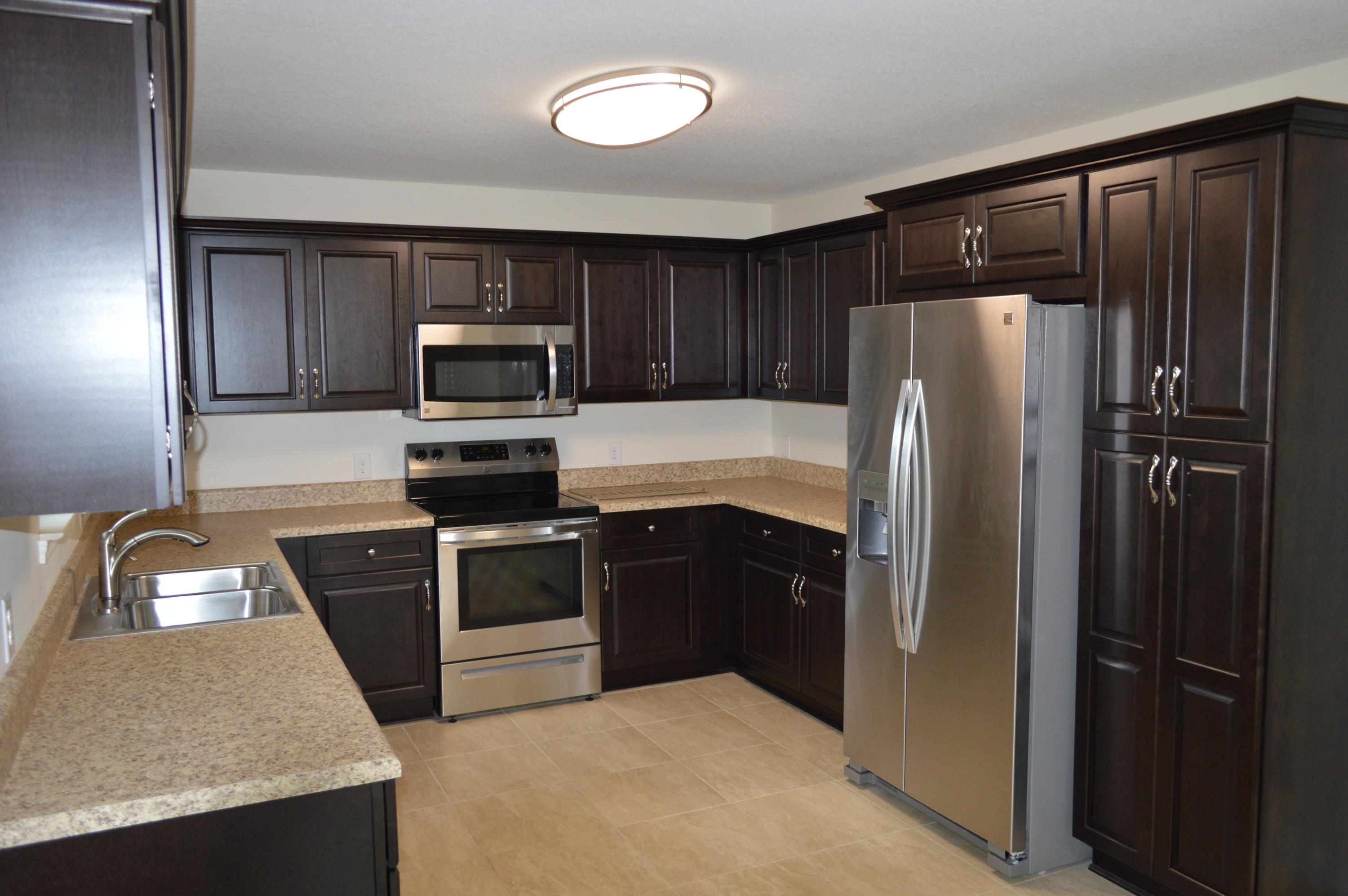 6144 Old Hickory Road Crestview, FL 32539 - Photo 8 of 18 a kitchen with granite countertop stainless steel appliances and refrigerator