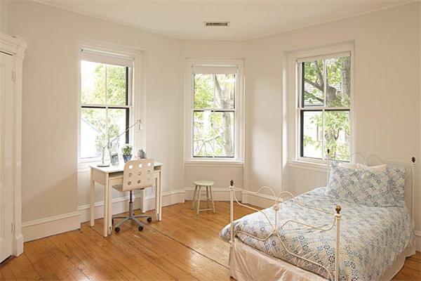 203 Aspinwall Avenue Brookline, MA 02446 - Photo 7 of 9 a living room with a bed furniture and a window