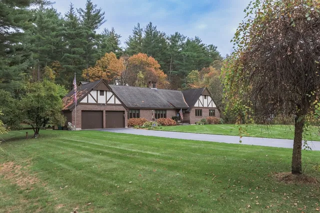 a house with huge green field in front of it