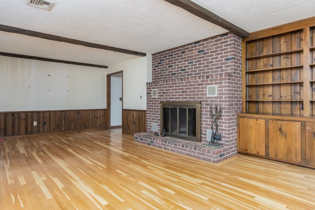 21 Saddle Lane Groton, MA 01450 - Photo 12 of 31 a view of a livingroom with an empty space and a fireplace