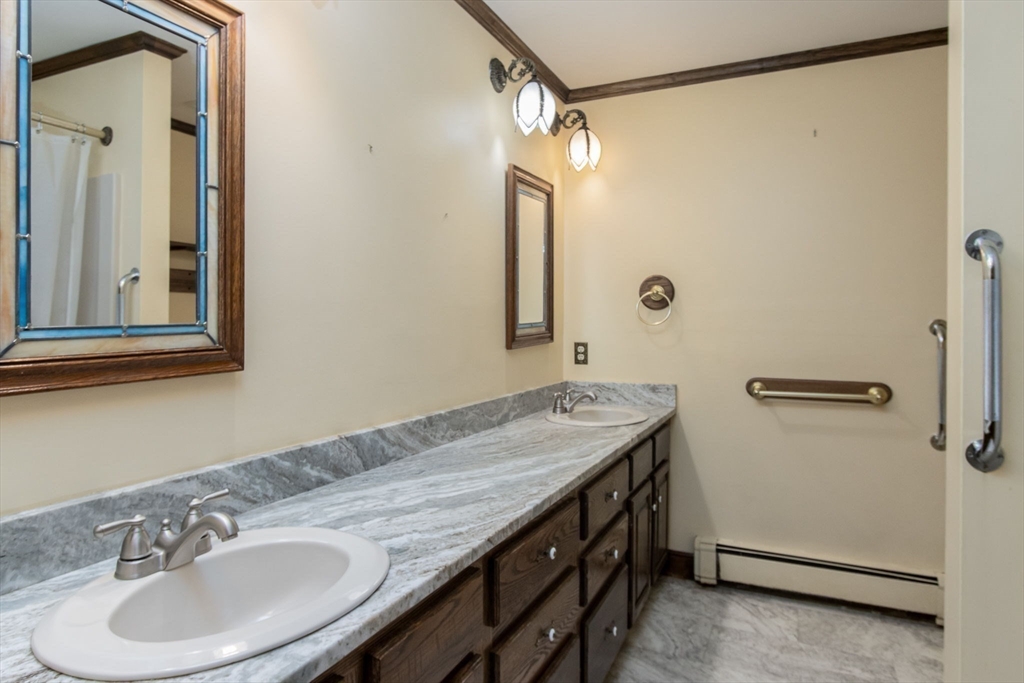 21 Saddle Lane Groton, MA 01450 - Photo 14 of 31 a bathroom with a sink and a mirror