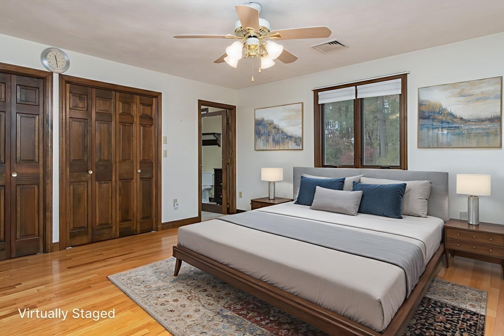 21 Saddle Lane Groton, MA 01450 - Photo 15 of 31 a bedroom with a large bed and a chandelier