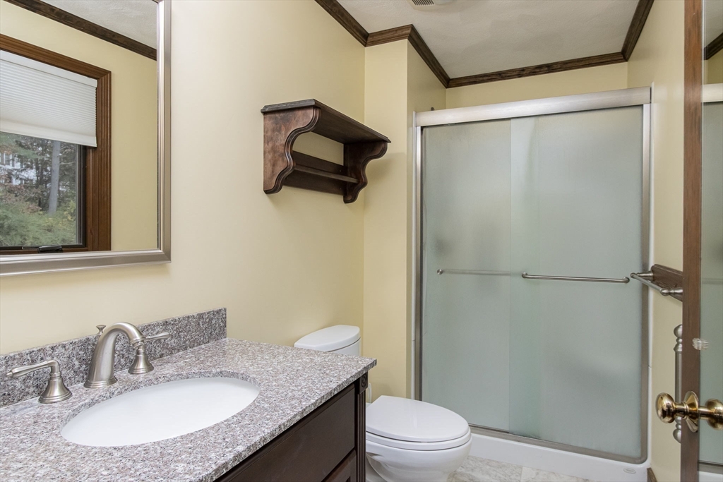 21 Saddle Lane Groton, MA 01450 - Photo 16 of 31 a bathroom with a granite countertop sink toilet and shower